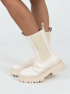 Boots Faux leather material Rounded toe Platform base Ankle pull tab Slip on style