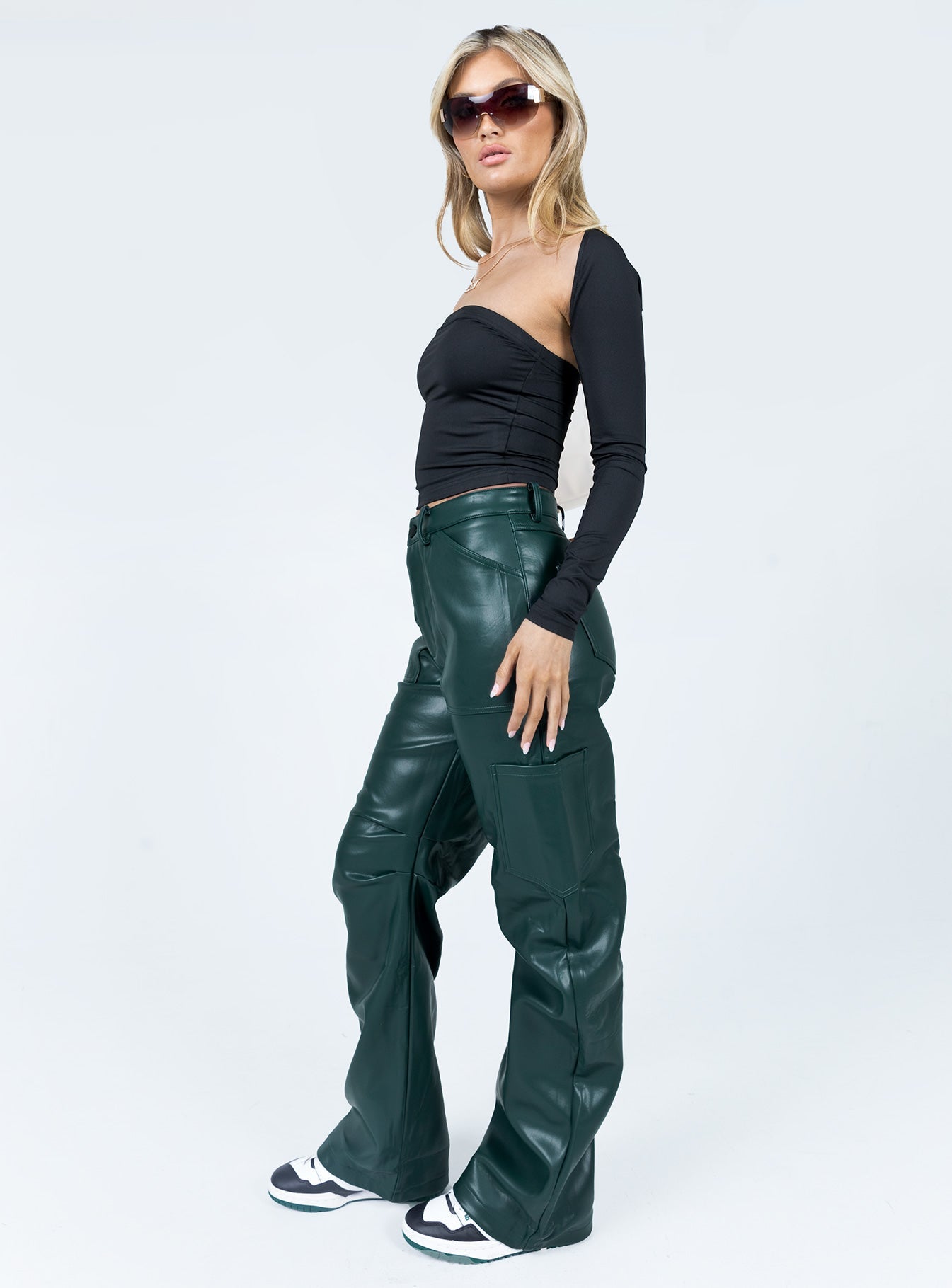 Pants 100% PU Faux leather material  Zip & button fastening  Belt looped waist  Six pockets  Pleated at inner thigh  Wide leg 