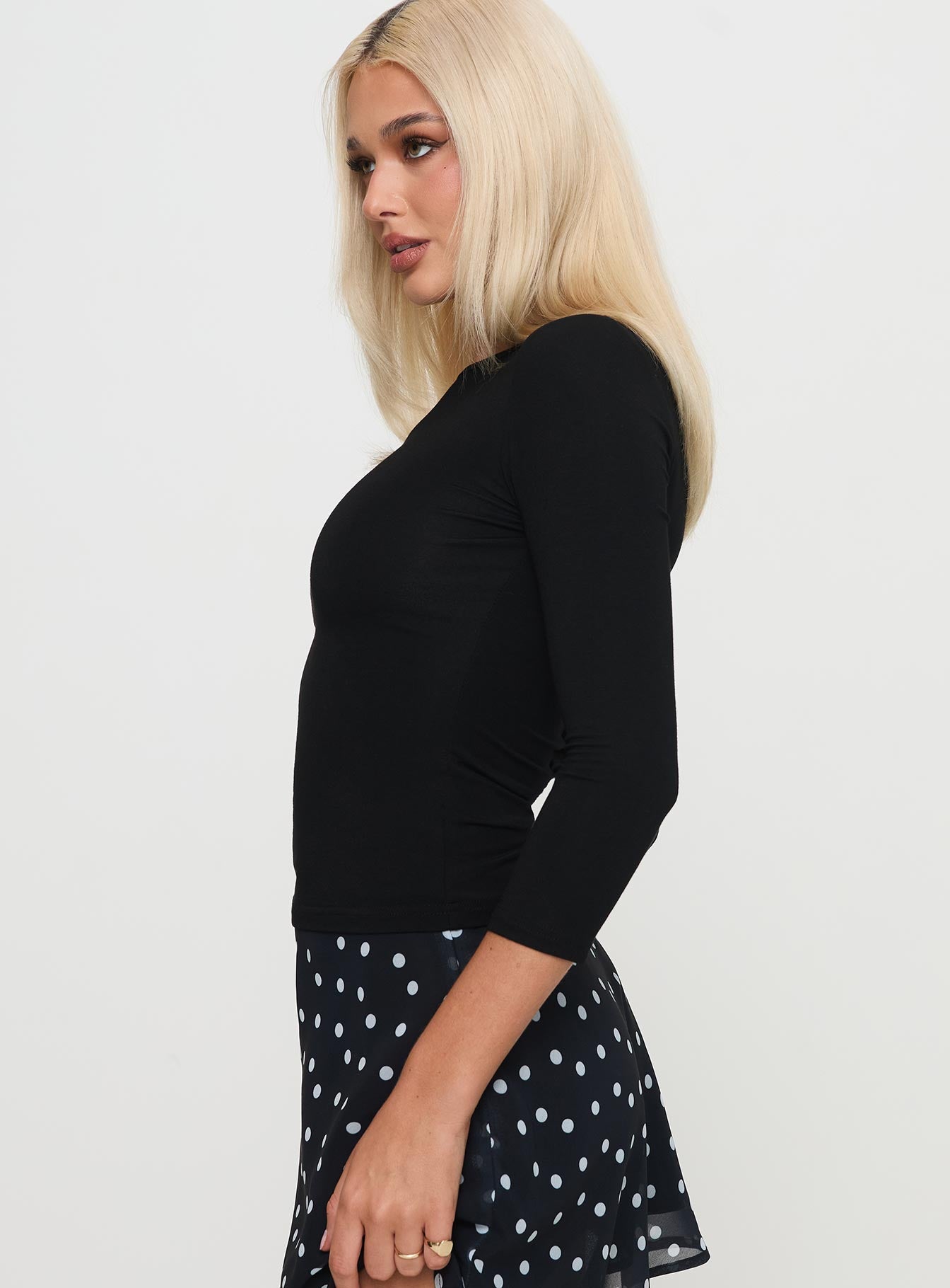 side view of model wearing Princess Polly Alouette Long Sleeve Top Black Three Fourth Sleeves Boat Neck 