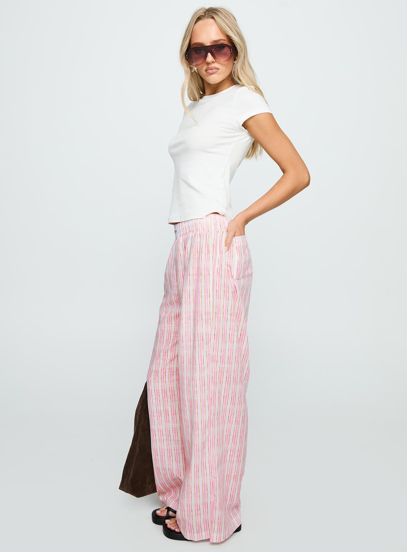 side view of model wearing Princess Polly Beach House Pants Pink Stripe High Waisted Pants 
