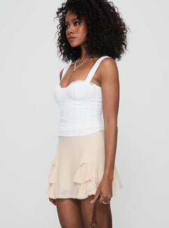   side view of model wearing Princess Polly Foalie Ruffle Mini Skirt Beige Mini Skirts 
