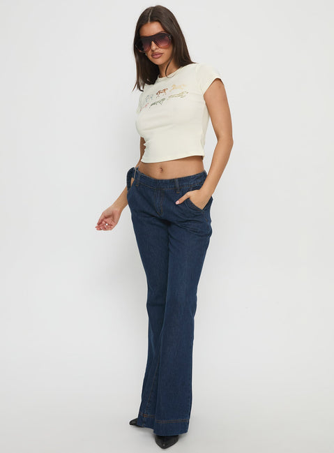 front view of model wearing Princess Polly Acapulco Low Rise Flare Jeans Dark Blue Wash Low Rise Jeans 