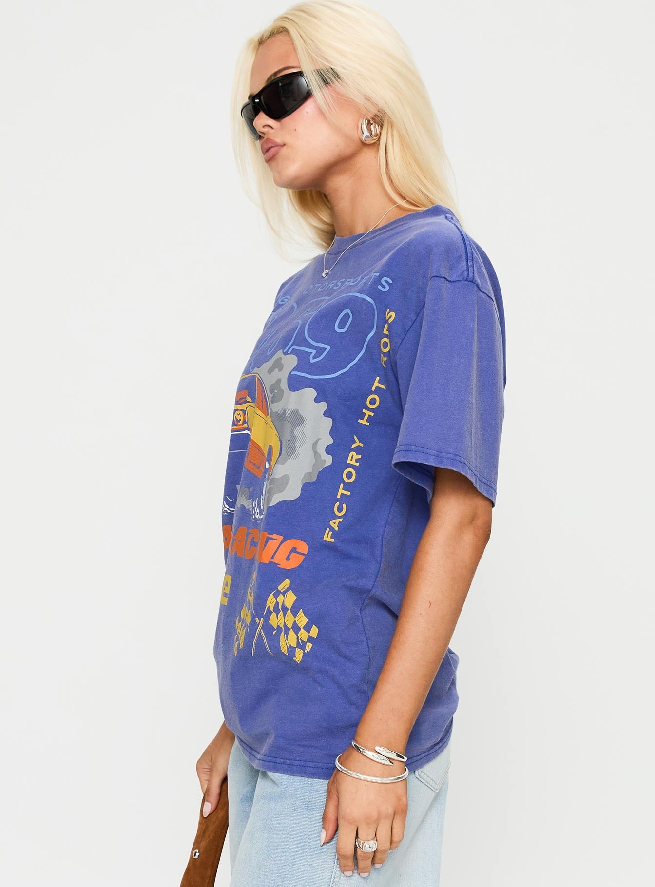 side view of model wearing Princess Polly Dodge 1969 Oversized Graphic Top Blue Half Sleeves Crew Neck 