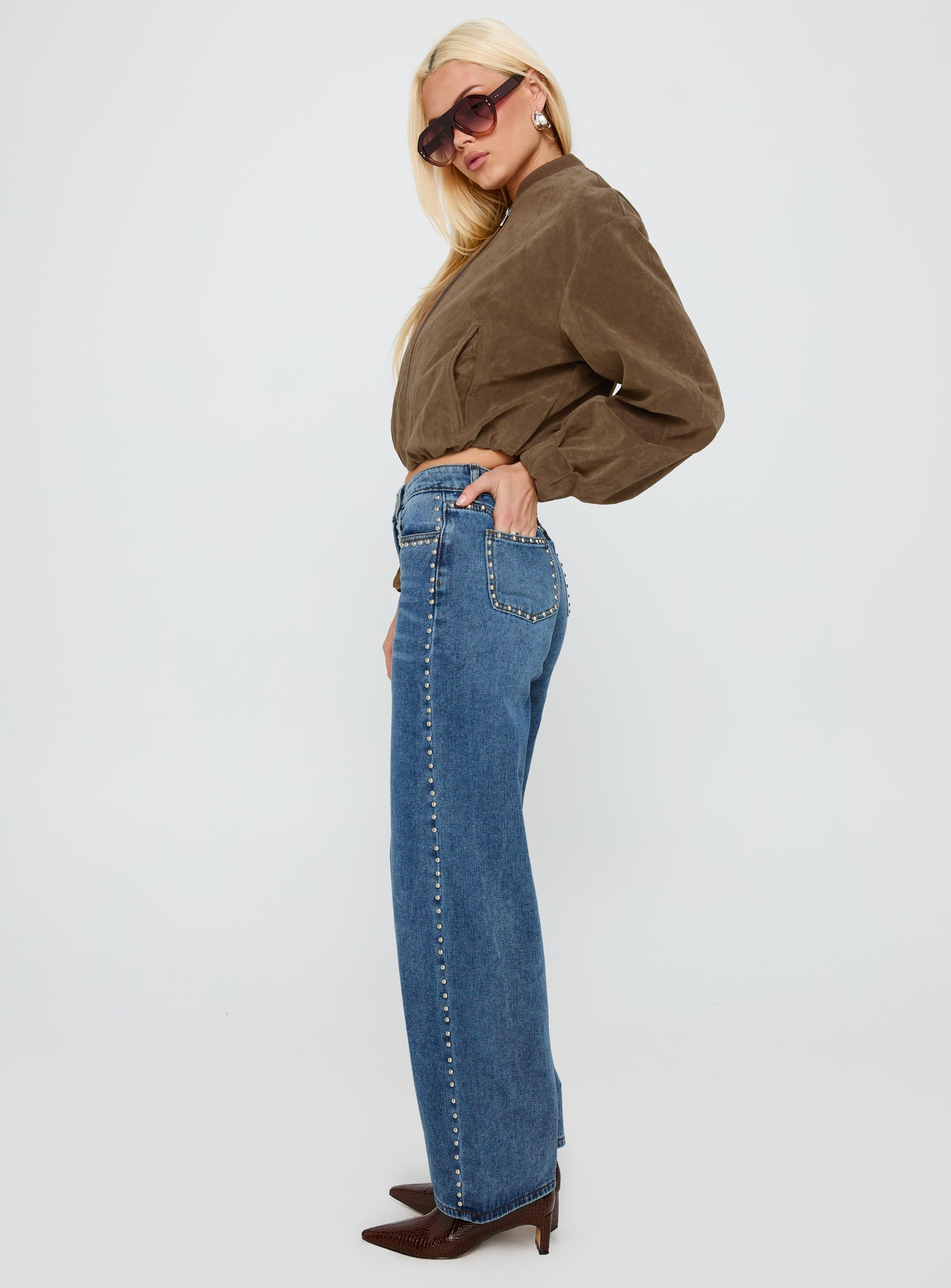 side view of model wearing Princess Polly Saving Up Stud Detail Jeans Mid Blue Mid Rise 