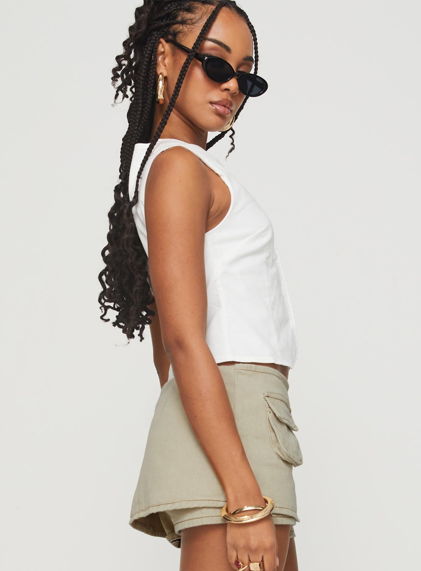 side view of model wearing Princess Polly Aguilera Top White Sleeveless Crew Neck 