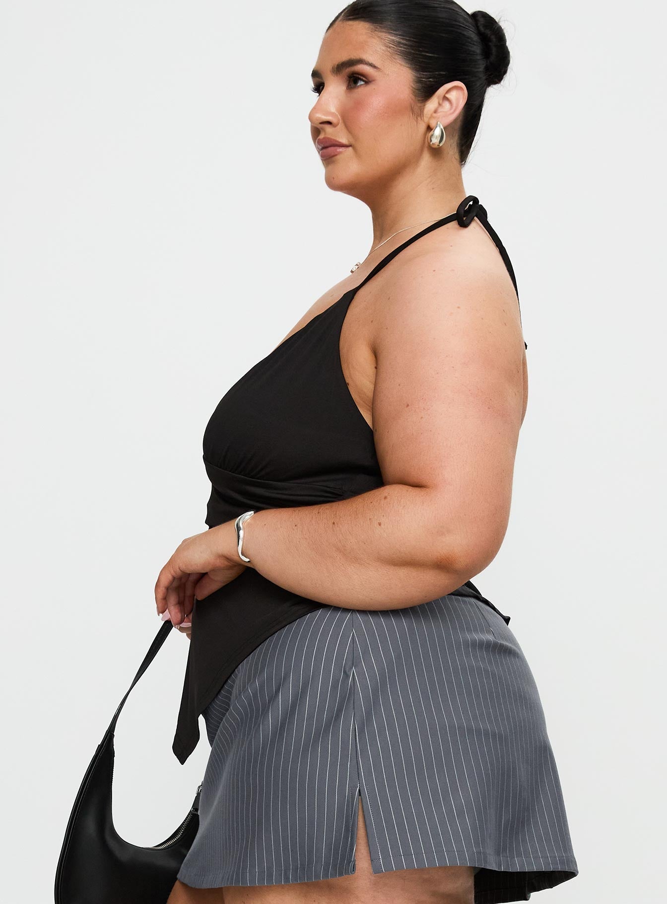 side view of model wearing Princess Polly Averee Halter Top Black Curve Sleeveless Plunger 