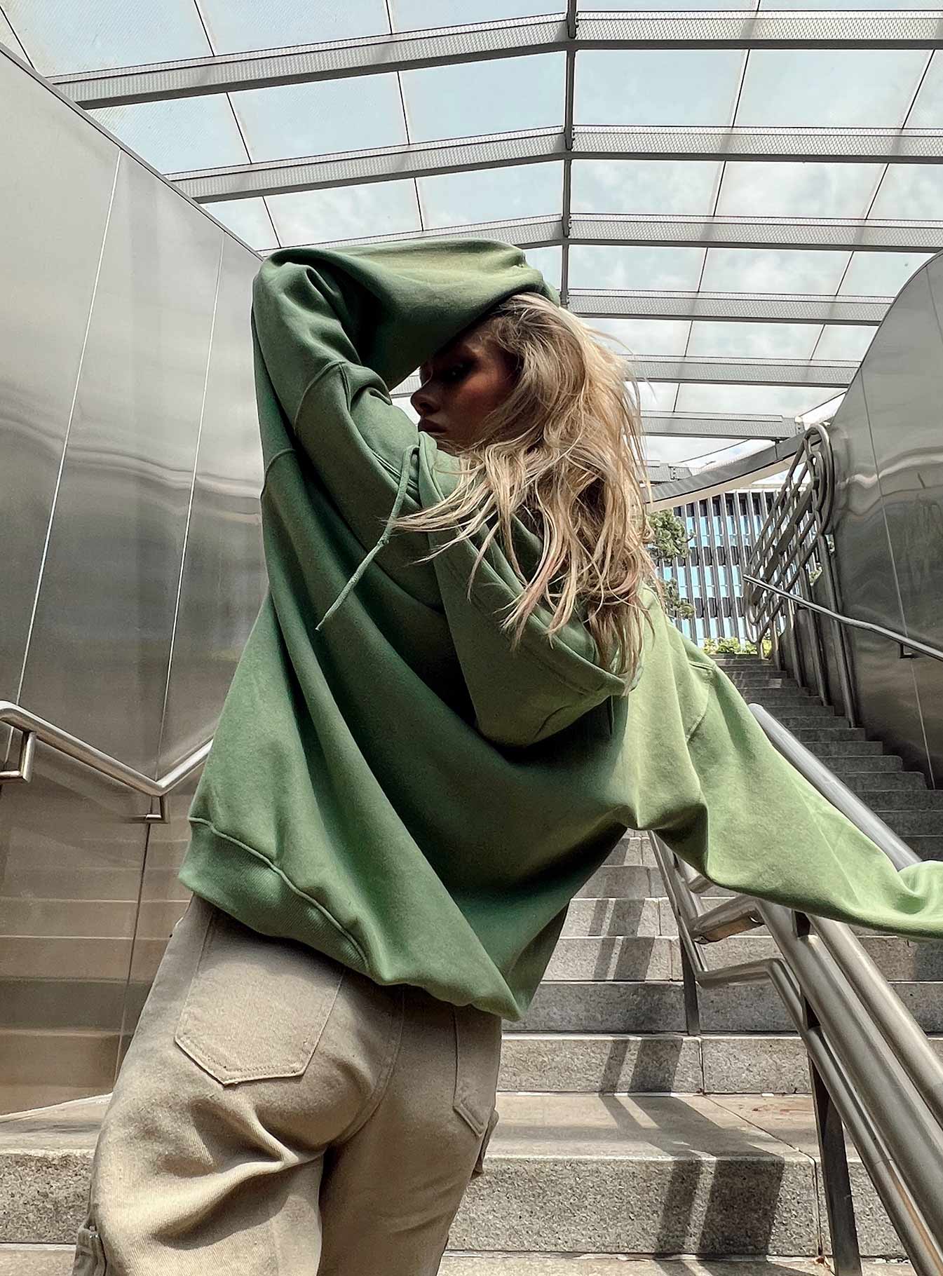 back view of model wearing Princess Polly Calder Zip Hooded Green Cropped 