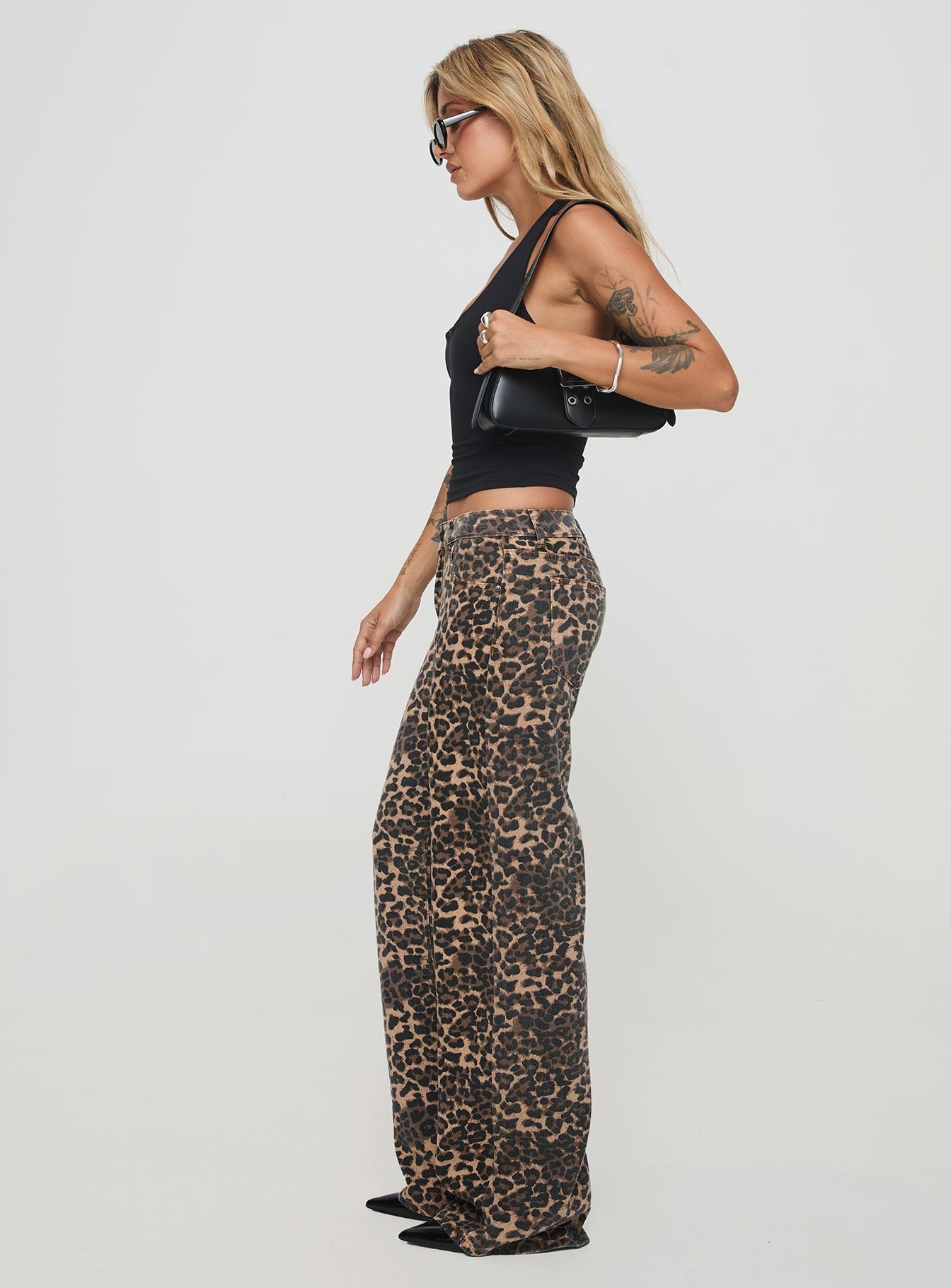 side view of model wearing Princess Polly Top Model Jeans Leopard High Waisted 
