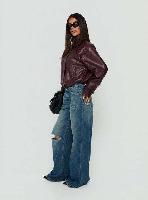 Discover the Ramos Low Rise Wide Leg Distressed Jeans Dark Indigo womens-jeans side view of model wearing Princess Polly
