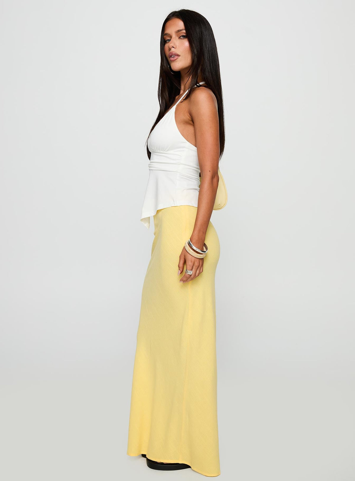   side view of model wearing Princess Polly Jodie Maxi Skirt Lemon Yellow Maxi Skirts Skirts 