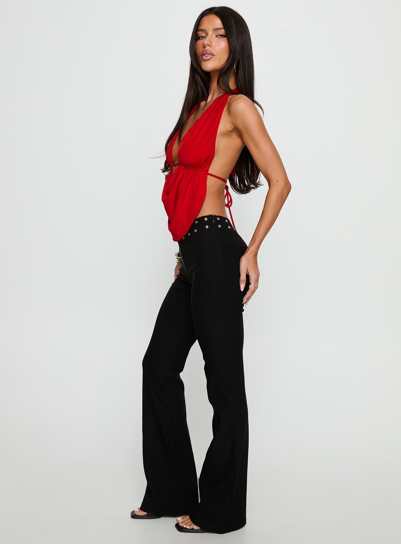 side view of model wearing Princess Polly Yevina Eyelet Flare Pant Black Low Rise Pants 