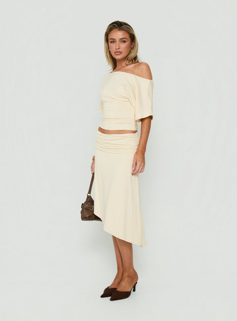 Discover the Sezzia Ruched Asymmetrical Midi Skirt Beige womens-skirts crafted with fitted design and length side view of model wearing Princess Polly