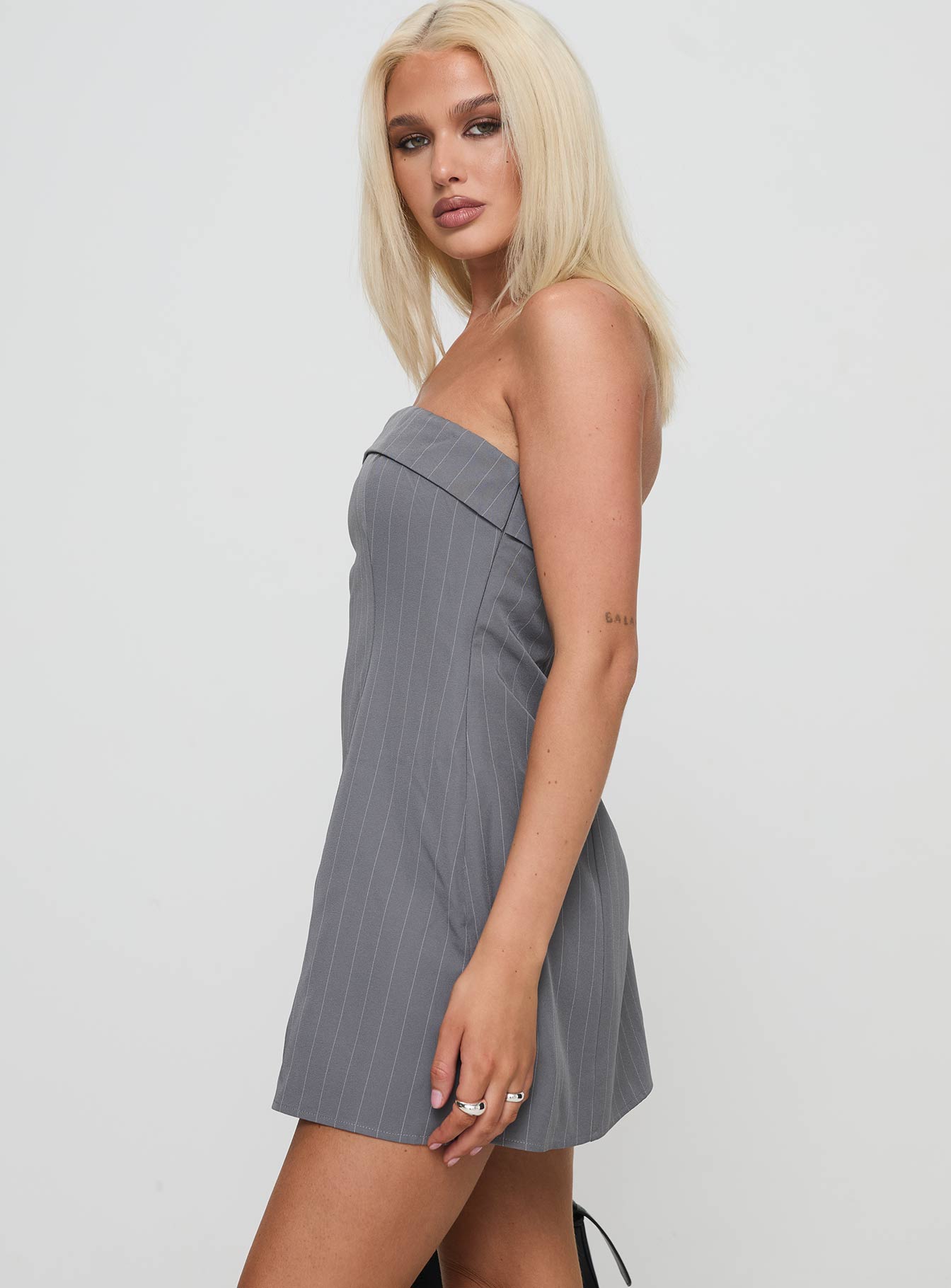 side view of model wearing Princess Polly Kaladin Strapless Mini Dress Grey Straight Neck 
