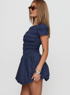 side view of model wearing Princess Polly Kennedia Shirred Bubble Hem Mini Dress Navy Boat Neck 