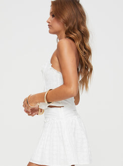 Halterneck top Boning structure, hook and eye fastening at front, split hem Non-stretch material, fully lined