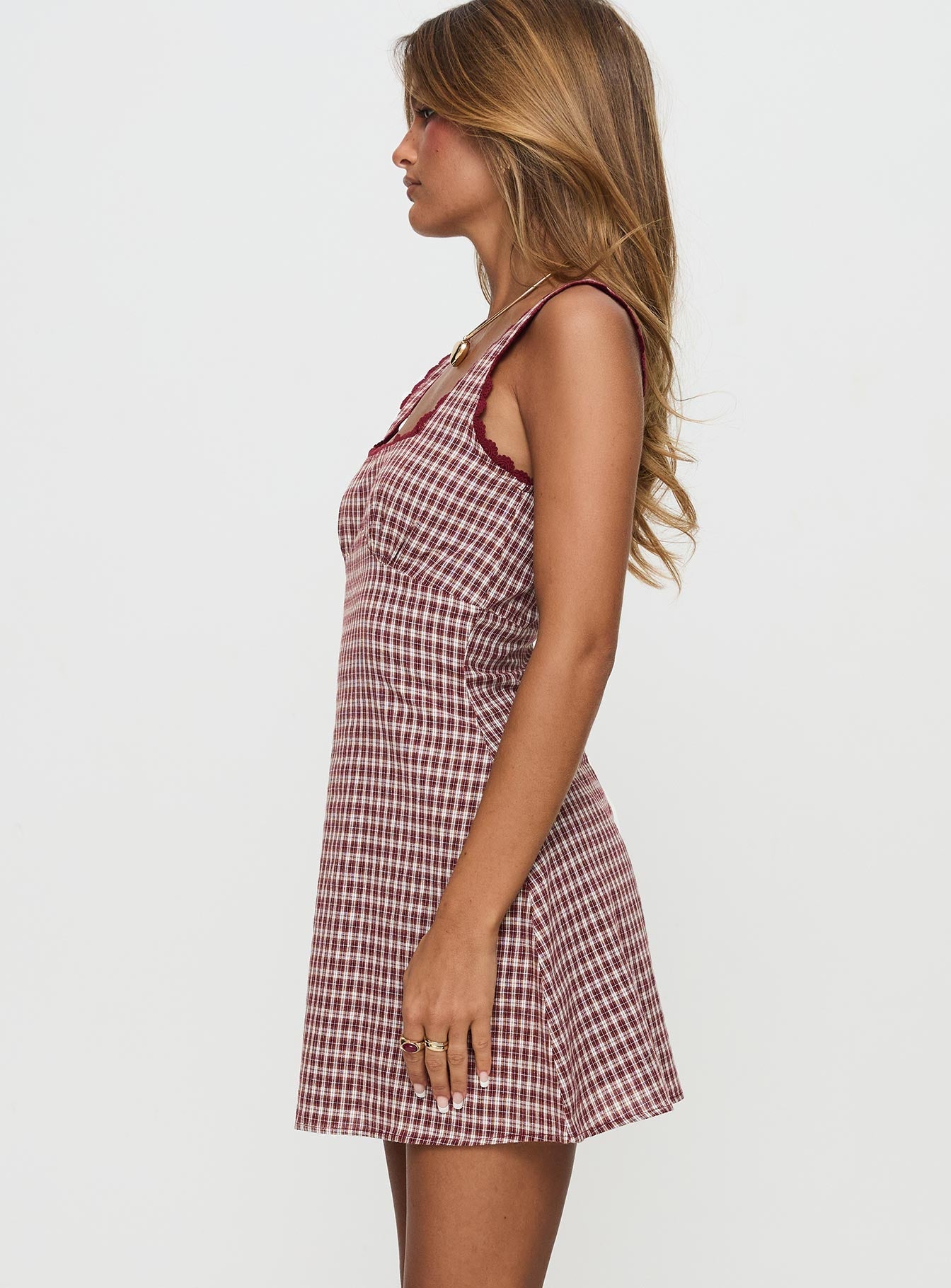 side view of model wearing Princess Polly Dasha Mini Dress Red Check Petite Square Neck 