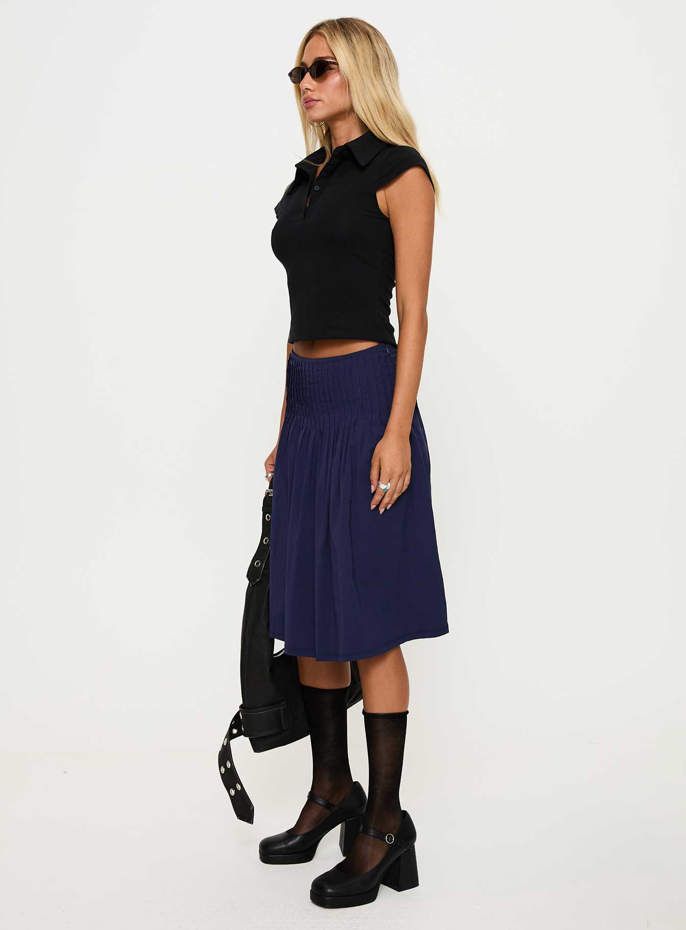   side view of model wearing Princess Polly Elaila Pleat Midi Skirt Navy Midi Skirts 