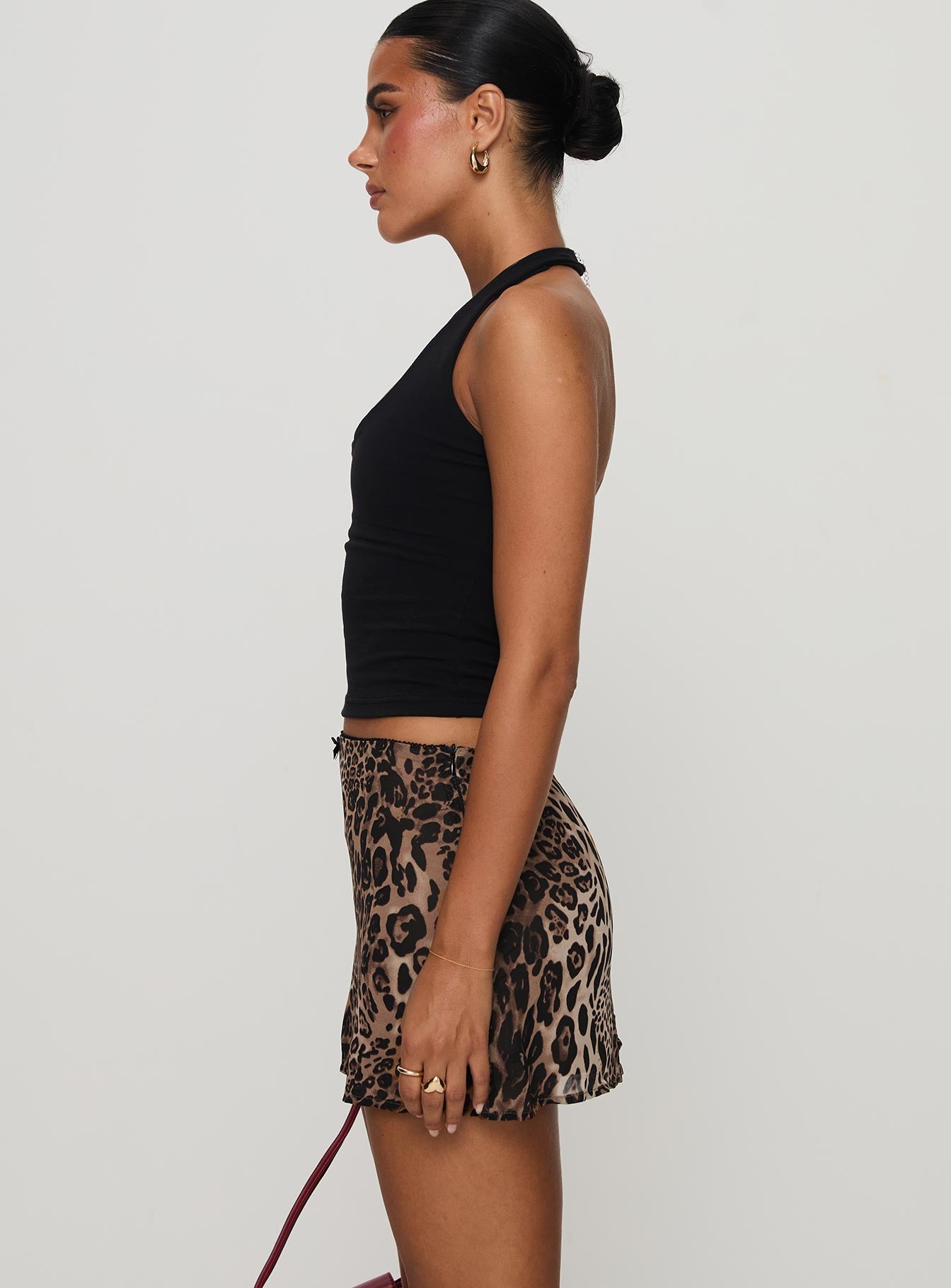   side view of model wearing Princess Polly Tejano Mini Skirt Leopard Petite Mini Skirts 