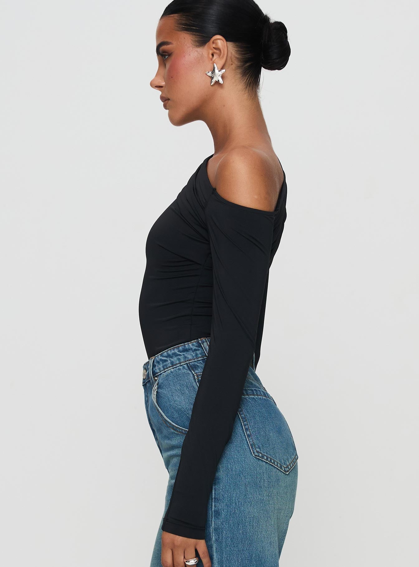 side view of model wearing Princess Polly Antilles One Shoulder Bodysuit Black Full Sleeves 