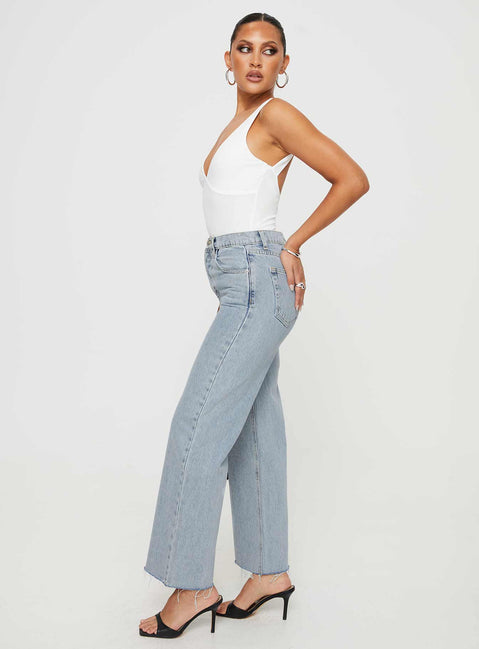 side view of model wearing Princess Polly Fawcett Jeans Light Wash Denim Petite High Waisted 