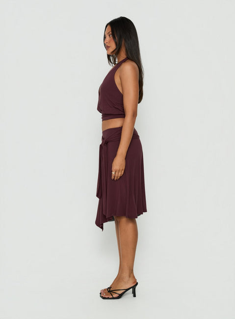 Discover the Soft Focus Tie Waist Midi Skirt Plum Noir with asymmetry shape side view of model wearing Princess Polly