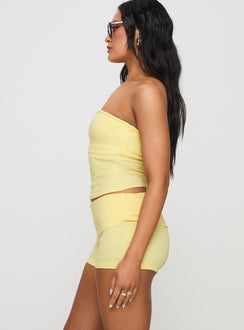 side view of model wearing Princess Polly Baseline Low Rise Rib Shorts Yellow Low Rise Shorts 