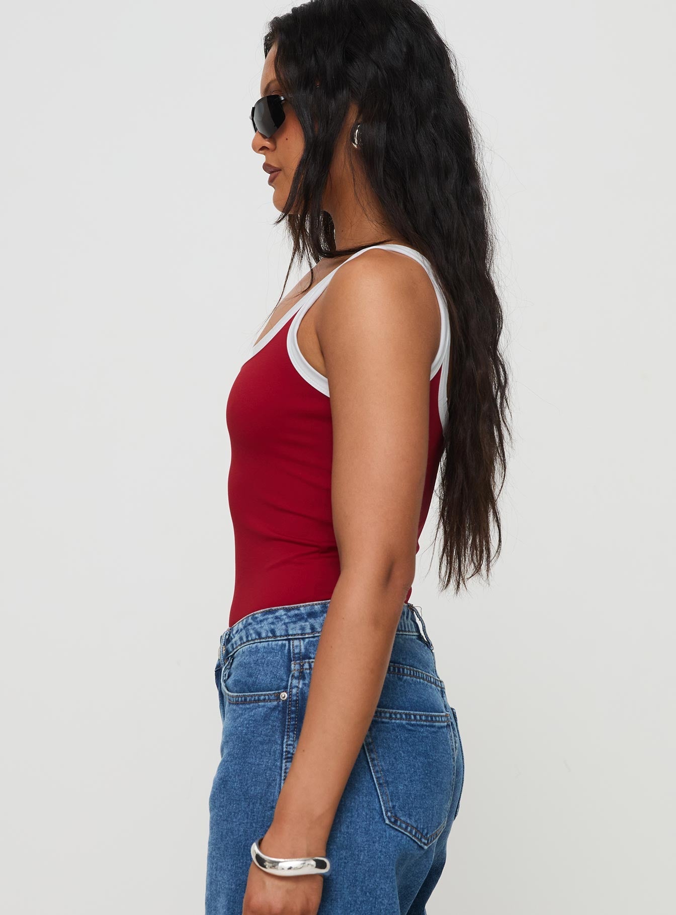 side view of model wearing Princess Polly Astrea Bodysuit Red / White Sleeveless Scoop Neck 