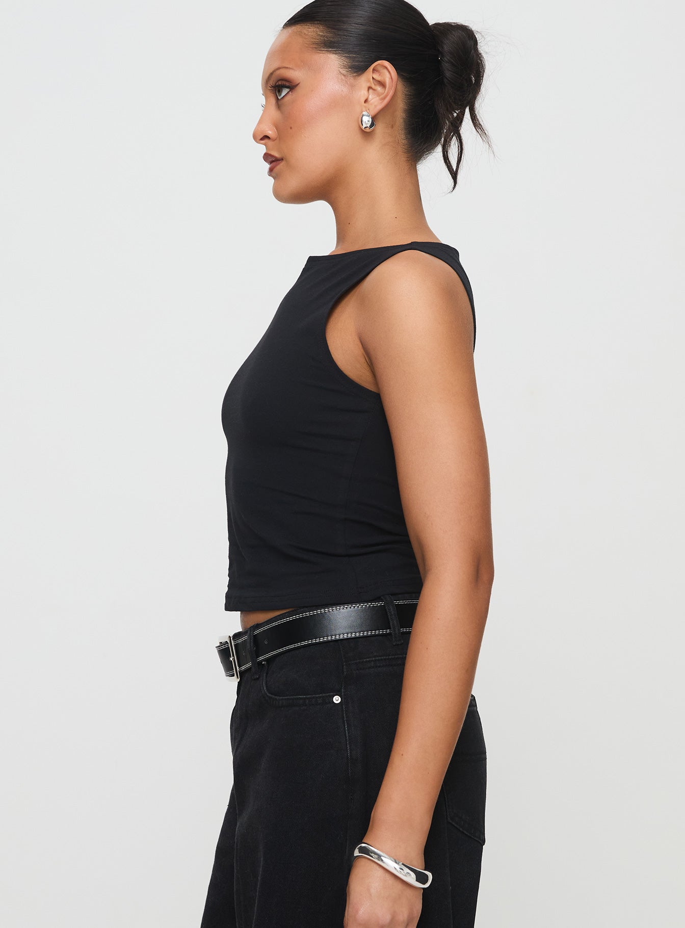 side view of model wearing Princess Polly Bleeker High Neck Top Black Sleeveless Boat Neck 