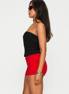 side view of model wearing Princess Polly Baseline Low Rise Rib Shorts Red Low Rise Shorts 
