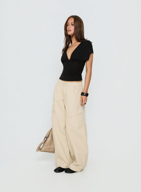 side view of model wearing Princess Polly Selective Memory Low Rise Wide Leg Cargo Pants Cream Low Rise Pants 