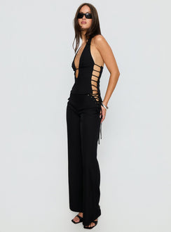 side view of model wearing Princess Polly Riane Lace Up Pants Black Mid Rise Pants 