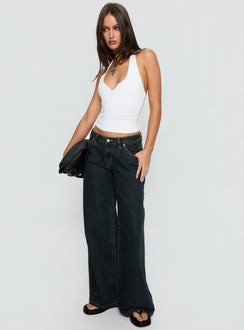 side view of model wearing Princess Polly Supercut Low Rise Baggy Pleat Jeans Grunge Wash Low Rise Jeans 