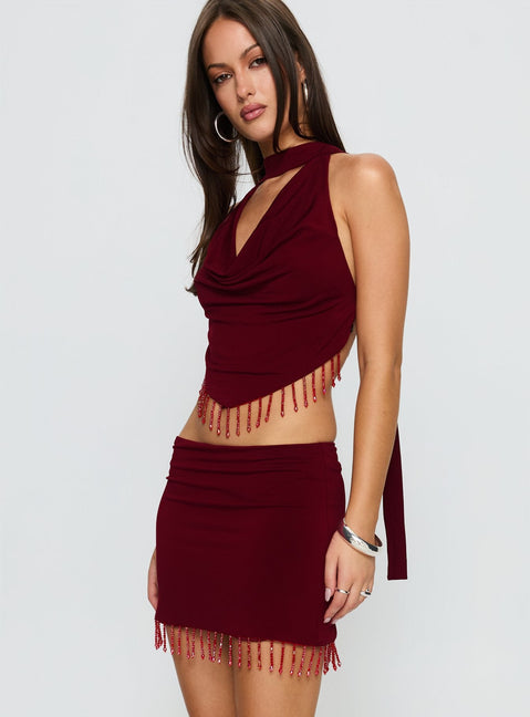   side view of model wearing Princess Polly Ginah Bead Tassel Mini Skirt Red Mini Skirts 