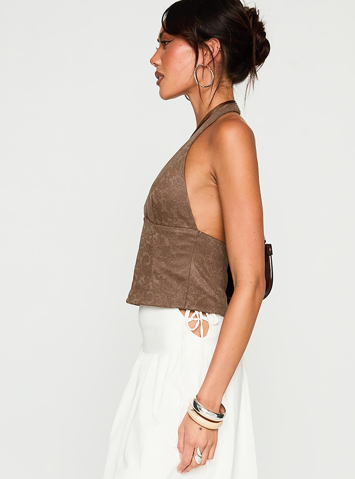 side view of model wearing Princess Polly Down The Line Halter Top Brown Sleeveless Plunger 