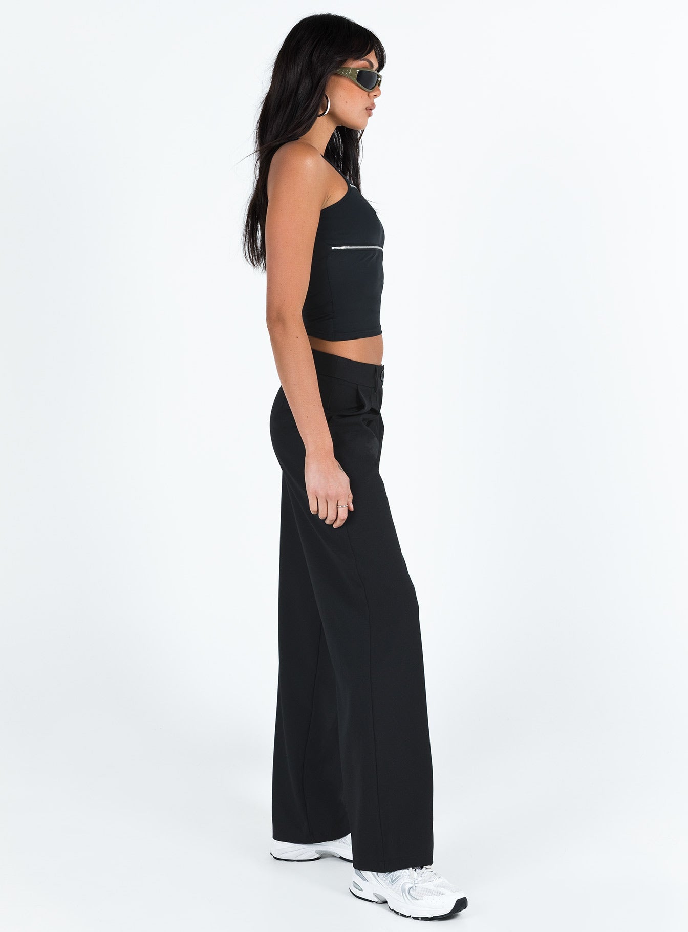 side view of model wearing Princess Polly Archie Low Rise Pants Black Tall Mid Rise 