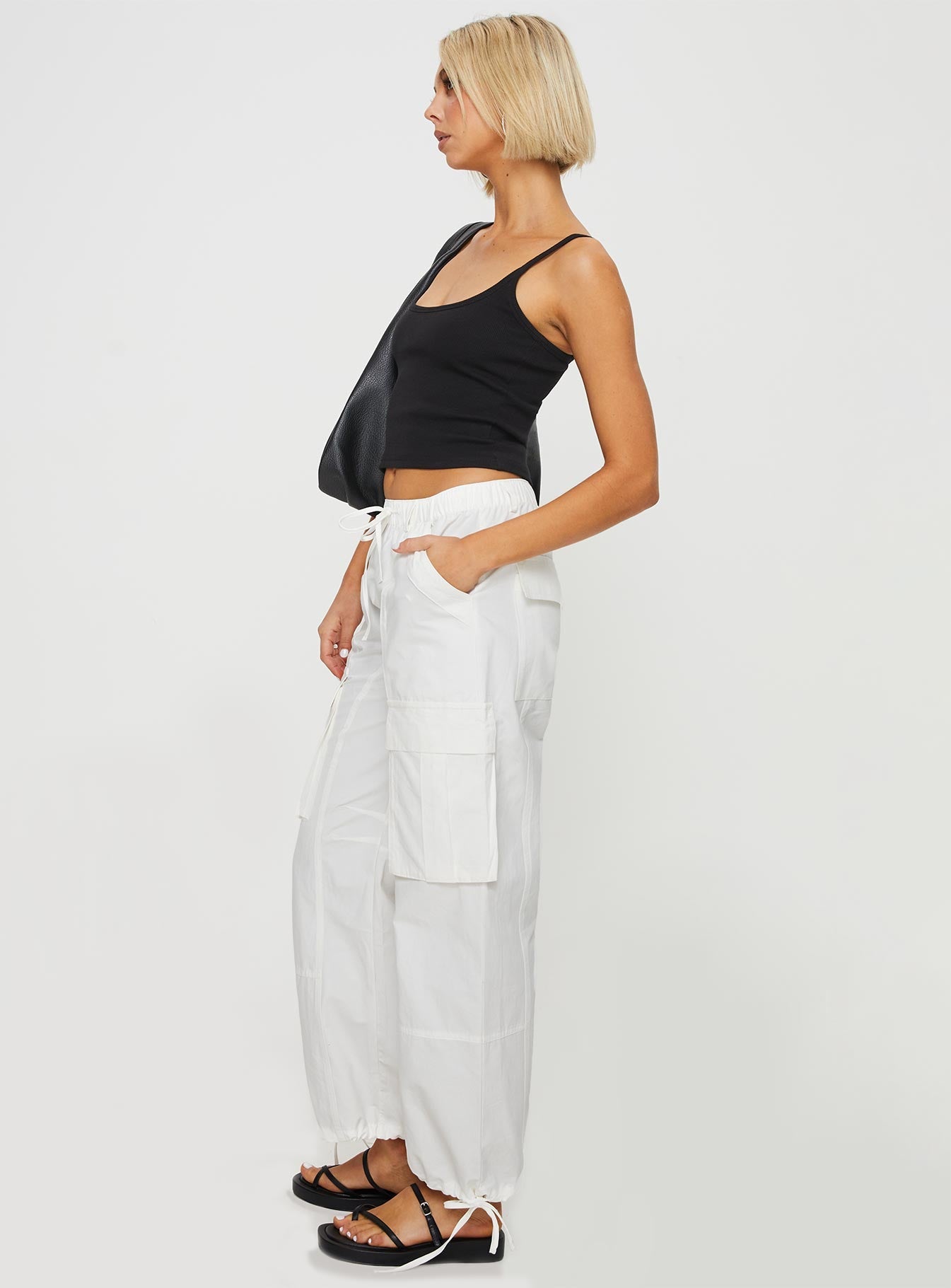 side view of model wearing Princess Polly Bilbury Cargo Pants White Low Rise Pants 