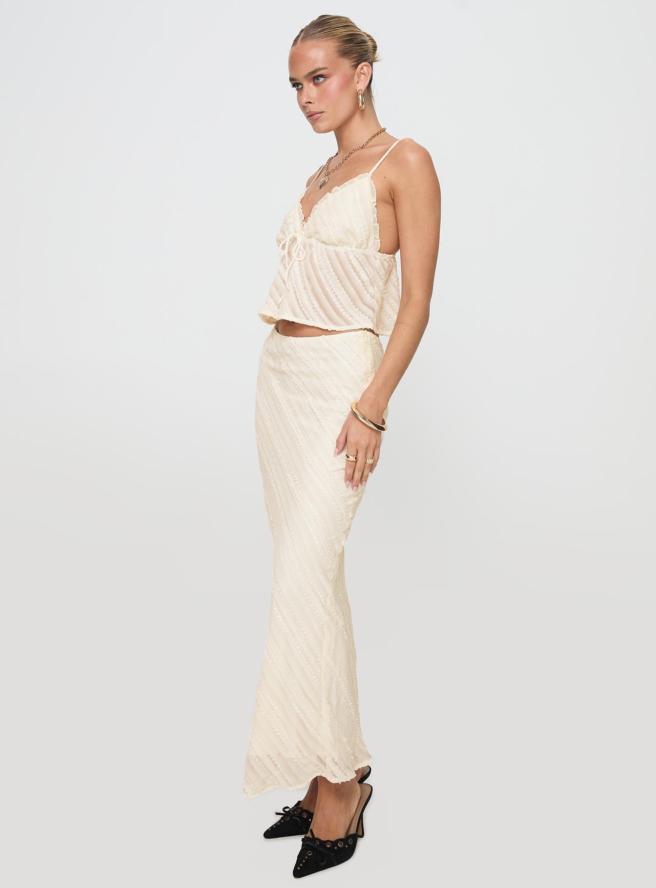   side view of model wearing Princess Polly Jacintha Maxi Skirt Cream Maxi 