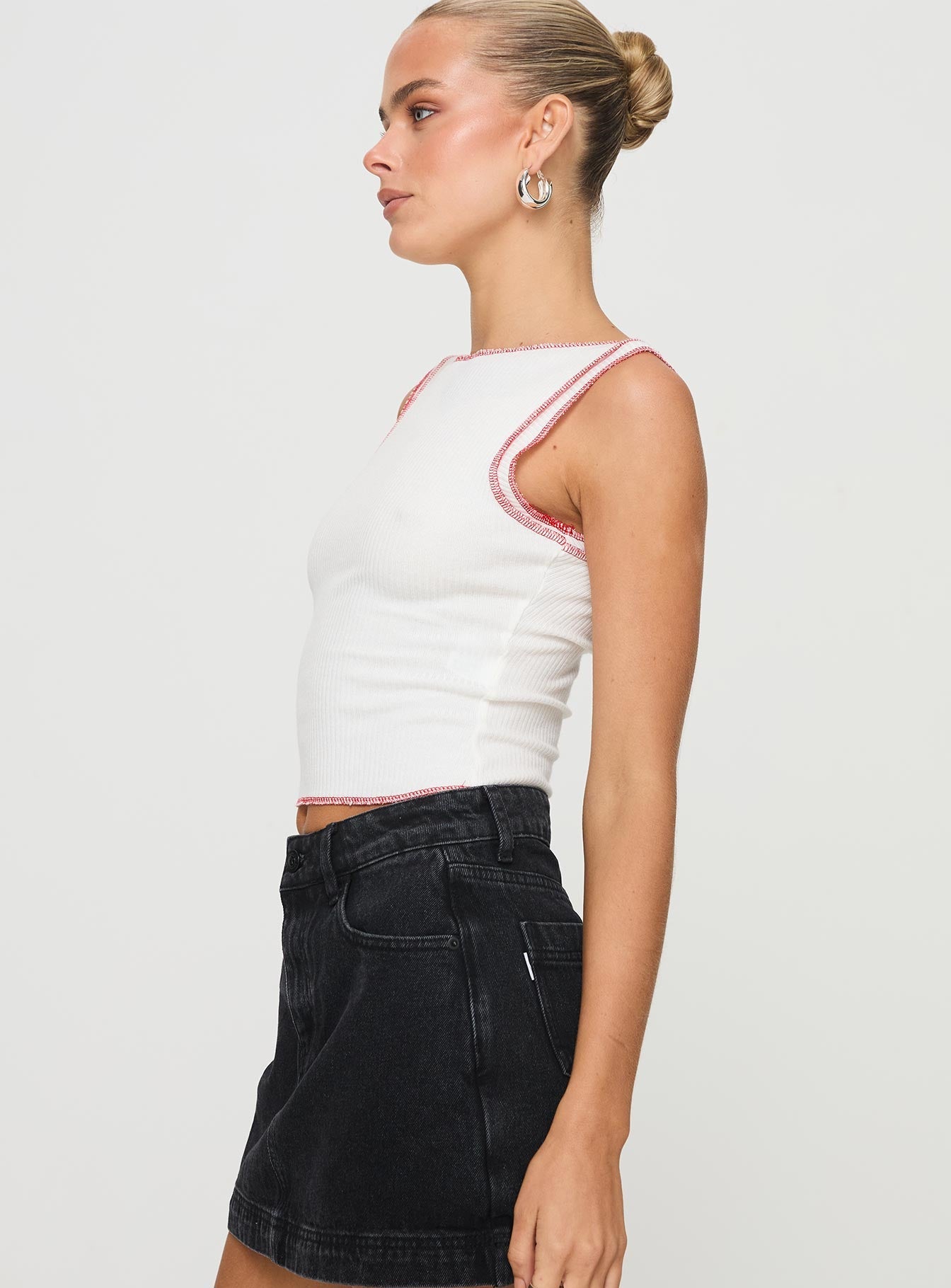 side view of model wearing Princess Polly Casado Top White Sleeveless Boat Neck 
