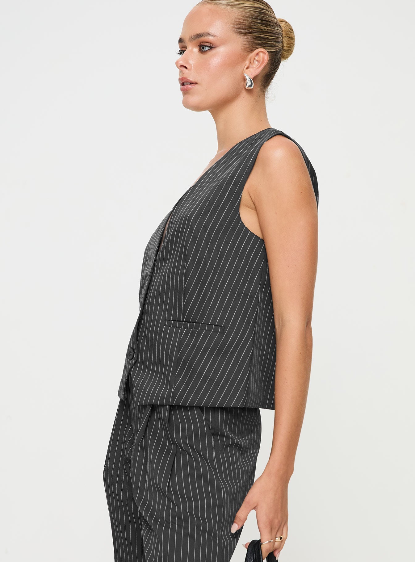 side view of model wearing Princess Polly In Office Vest Top Grey Sleeveless V-Neck 