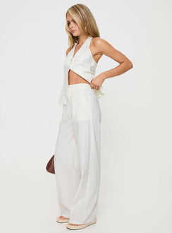 White Matching linen set Halter neck top, fixed halter strap, button fastening at front, twin hip pockets High rise pants, belt looped waist, zip and button fastening, elasticated waistband at back, twin hip pockets, straight leg