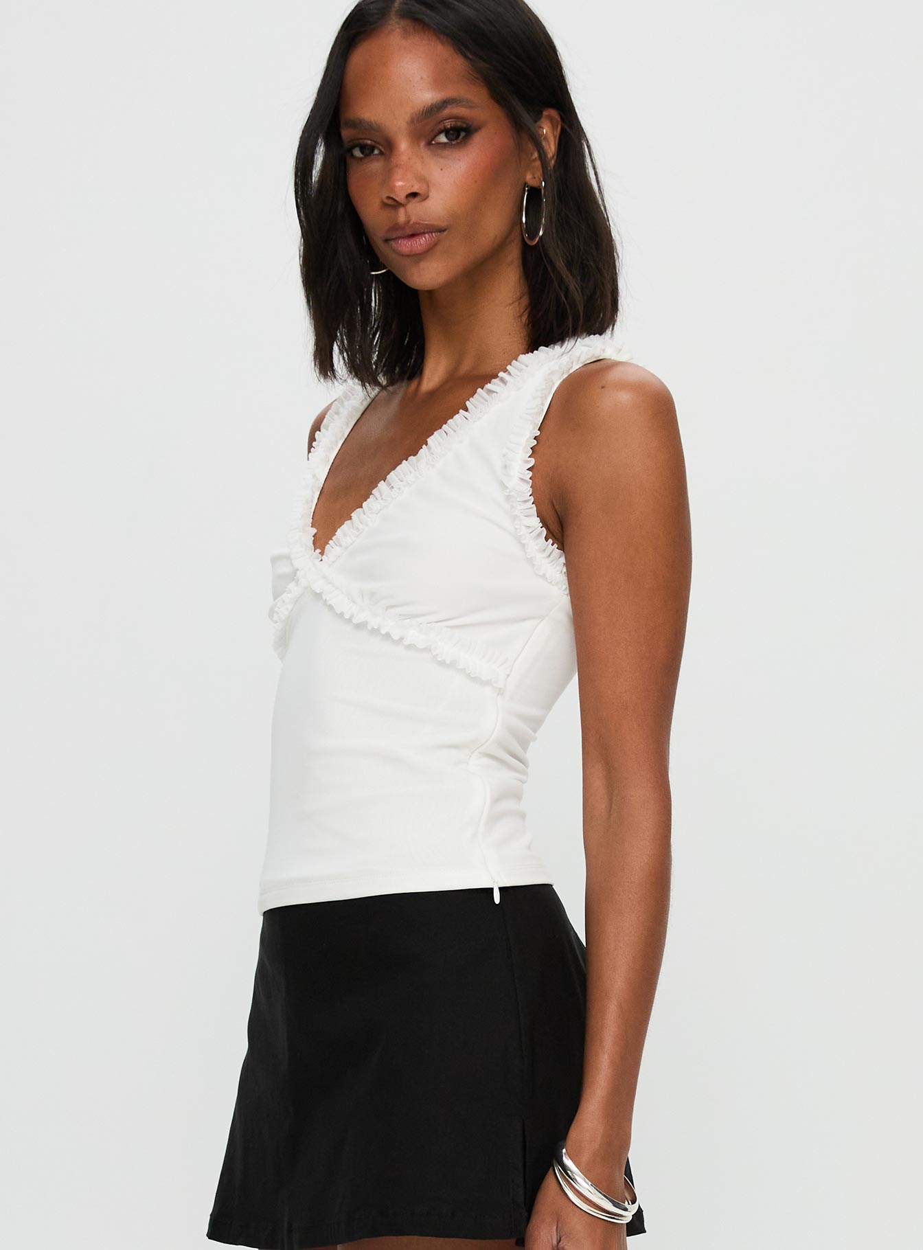 side view of model wearing Princess Polly Danyia Frill Top White Sleeveless V-Neck 