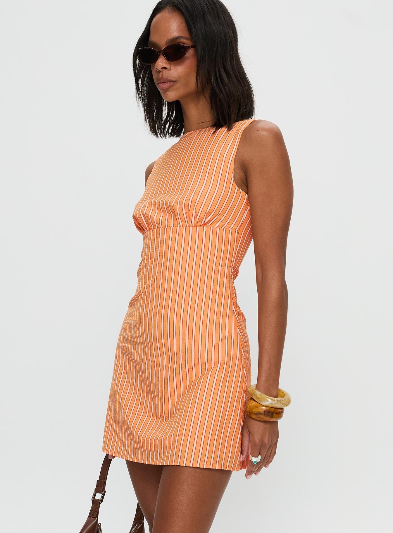 side view of model wearing Princess Polly Ellesandra Boat Neck Mini Dress Orange Stripe Boat Neck 
