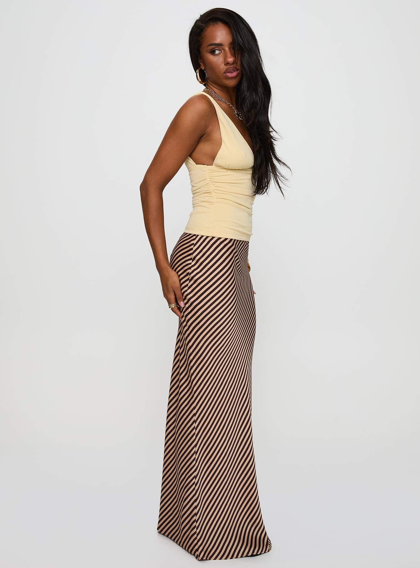 Capturing the Eliena Maxi Skirt Multi Petite in womens-skirts with maxi length and striped print side view of model wearing