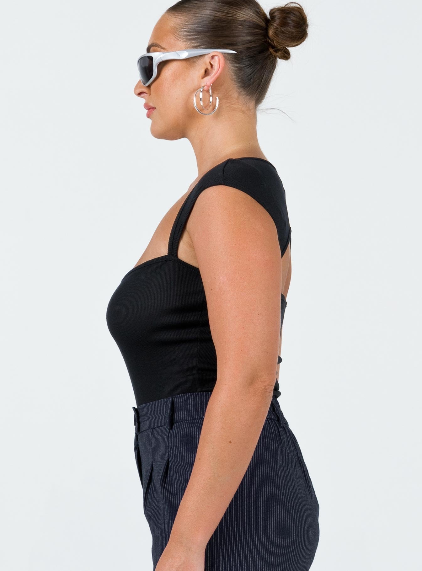 side view of model wearing Princess Polly Halia Bodysuit Black Short Sleeves 