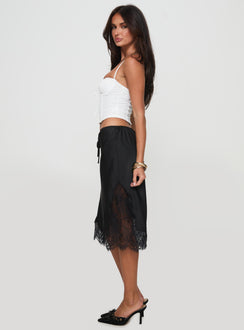   side view of model wearing Princess Polly Gervais Satin Midi Skirt Black Midi Skirts 