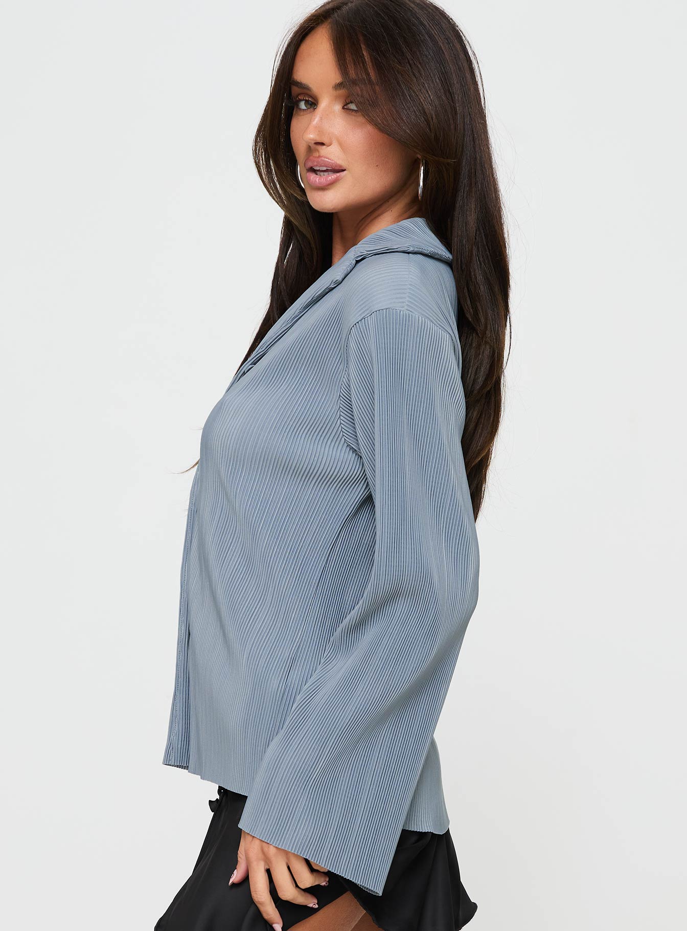 side view of model wearing Princess Polly Louie Pleated Shirt Blue Full Sleeves V-Neck 