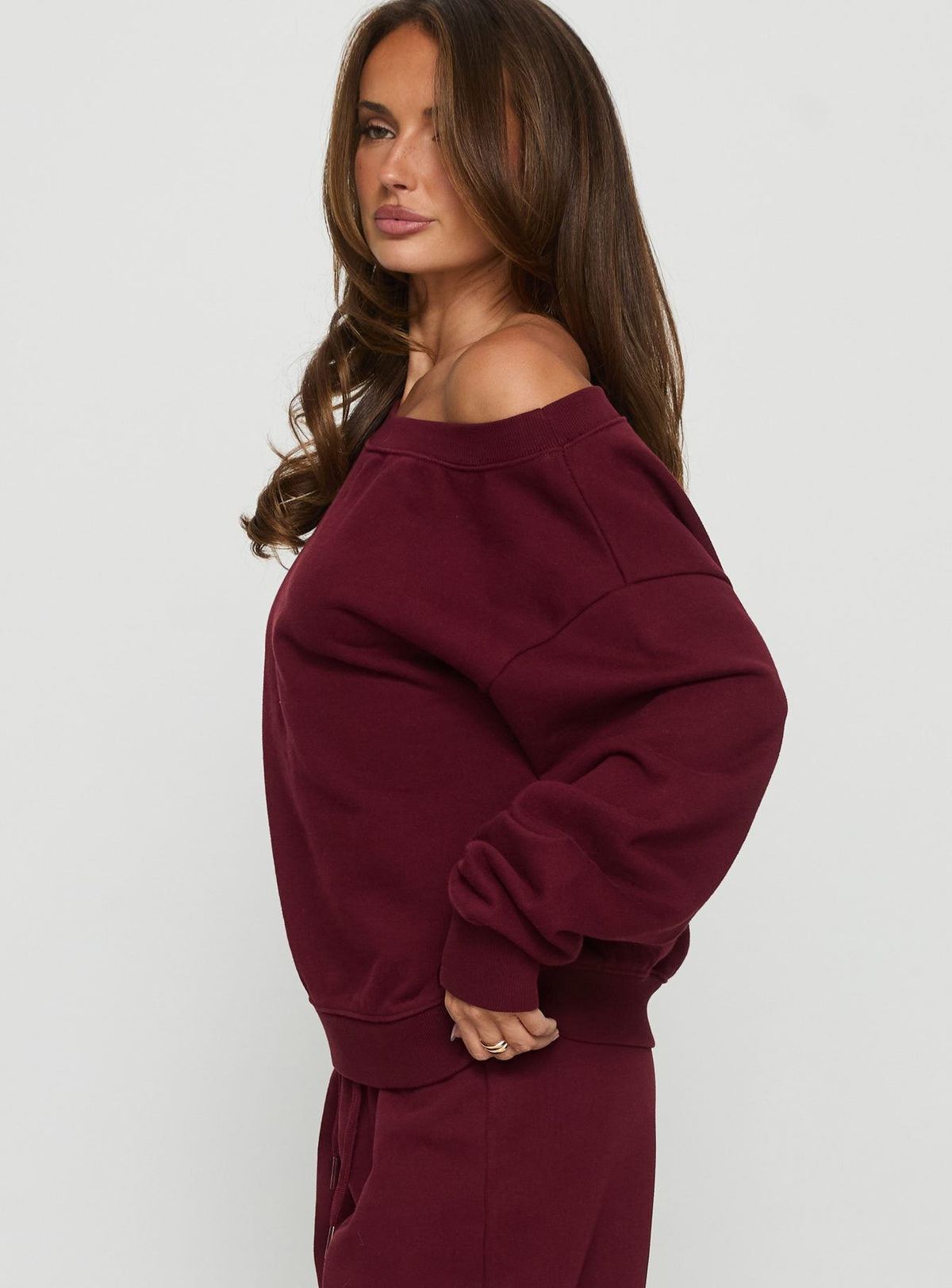side view of model wearing Princess Polly Wellness Off the Shoulder Jumper Currant cropped Jumpers 
