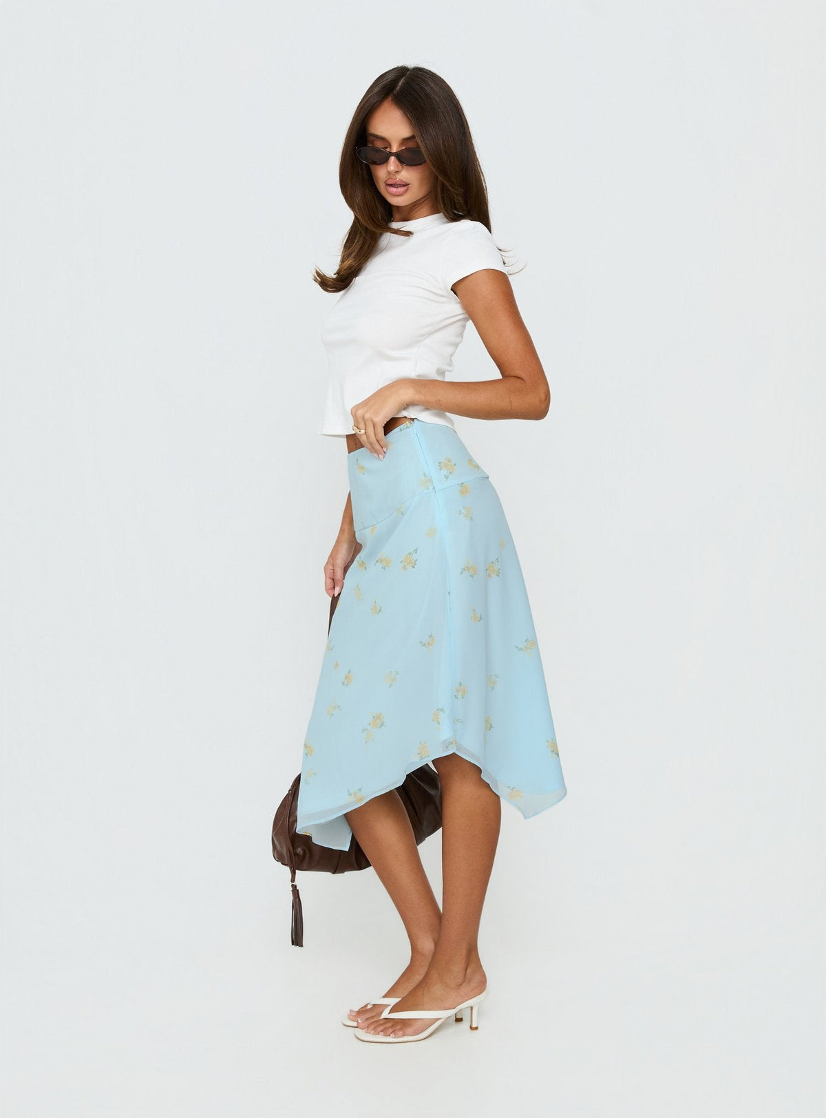   side view of model wearing Princess Polly Daphene Asymmetrical Midi Skirt Blue Floral Midi Skirts Skirts 