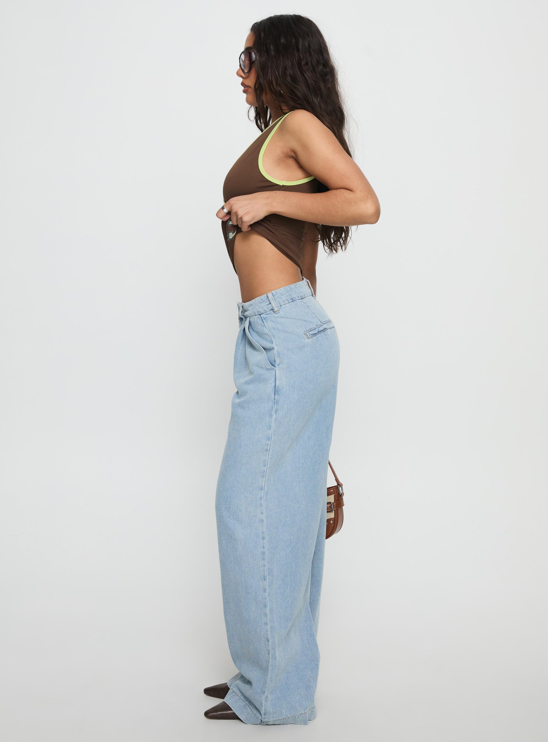 side view of model wearing Princess Polly Siloh Wide Leg Denim Jeans Blue Mid Rise Jeans 