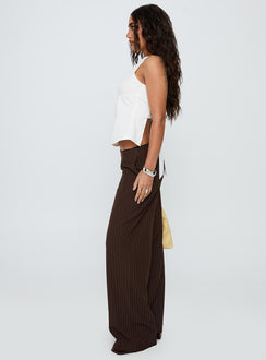 side view of model wearing Princess Polly Khane Low Rise Wide Leg Pant Brown Pinstripe Low Rise Pants 